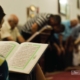 Reading Quran, by Obayda Jamal