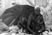 The Street Grandma with Hand of Flowers by Karthick Saravanan