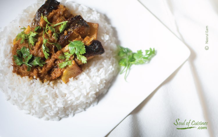 Rohu fish curry on top of steamed rice